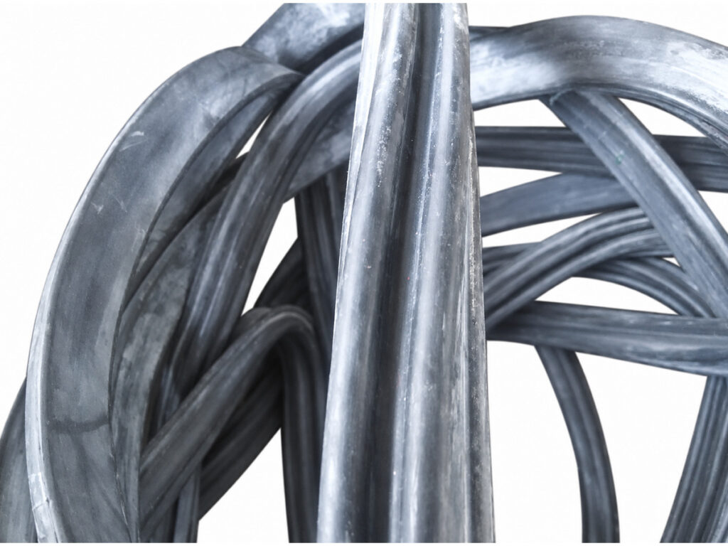 Close-up of coiled black sealing profiles — Rail Door High-Speed Railway Train Inflatable Seal; Bus Door Inflatable Seal