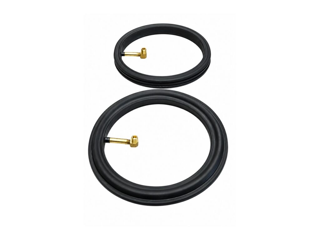 Two black circular seals with brass air fittings — Bulk Solids Feeder Inflatable Seal