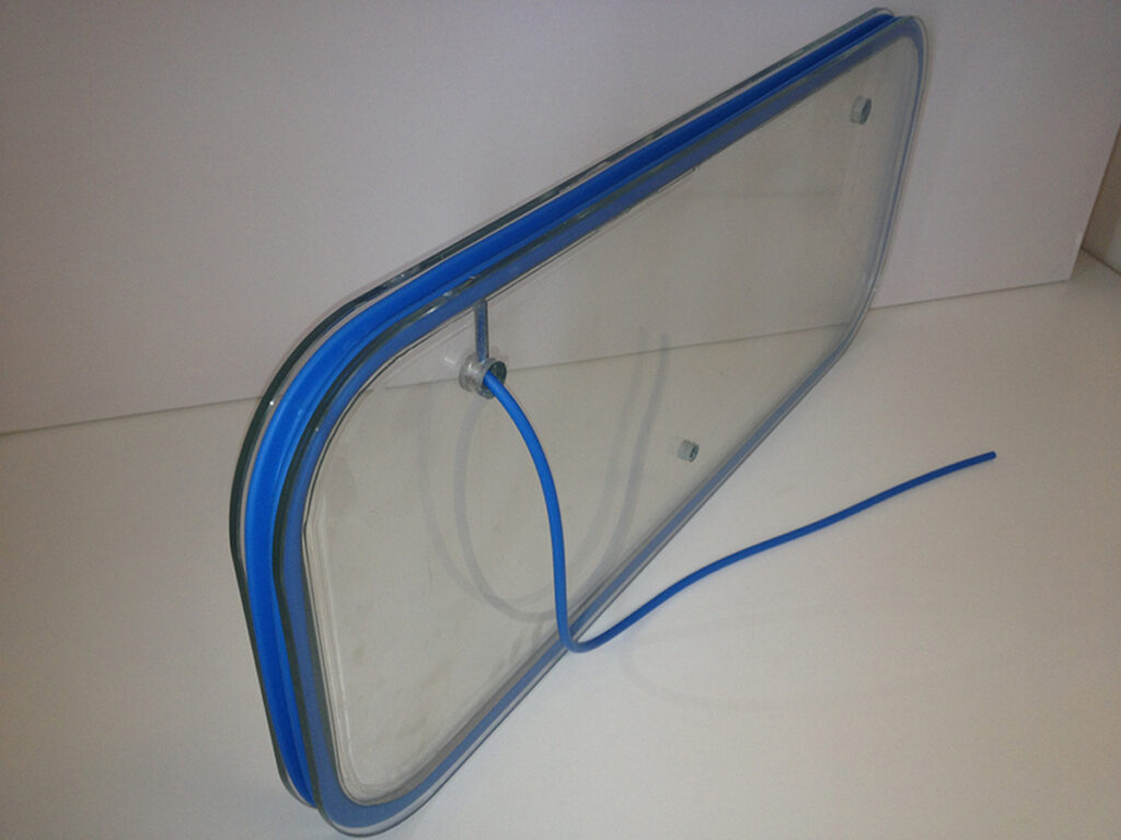 Transparent rectangular panel with a blue perimeter seal and attached blue tube — Laboratory Observation Window Inflatable Seal