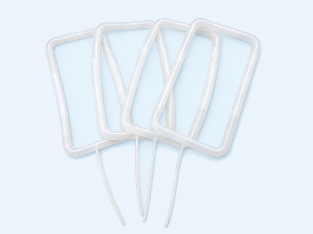 Four translucent rectangular seals with attached tubes — Custom Inflatable Seals